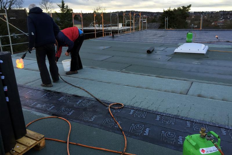 Rechtzeitig zur Weihnachtspause stellen die Dachdecker die W&auml;rmed&auml;mmung und die Abdichtung des Daches fertig.
